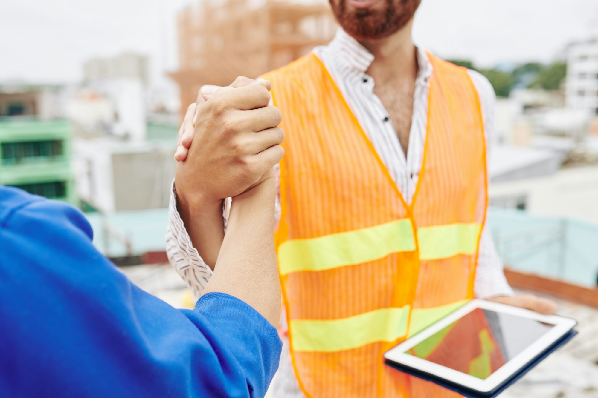 Construction workers shaking hands