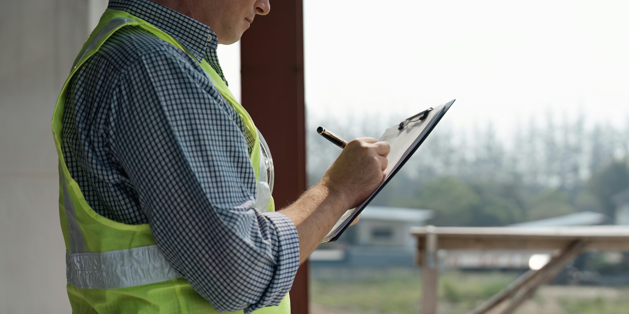 Young engineering, looking at paperwork on the inspecting the reconstructed construction and